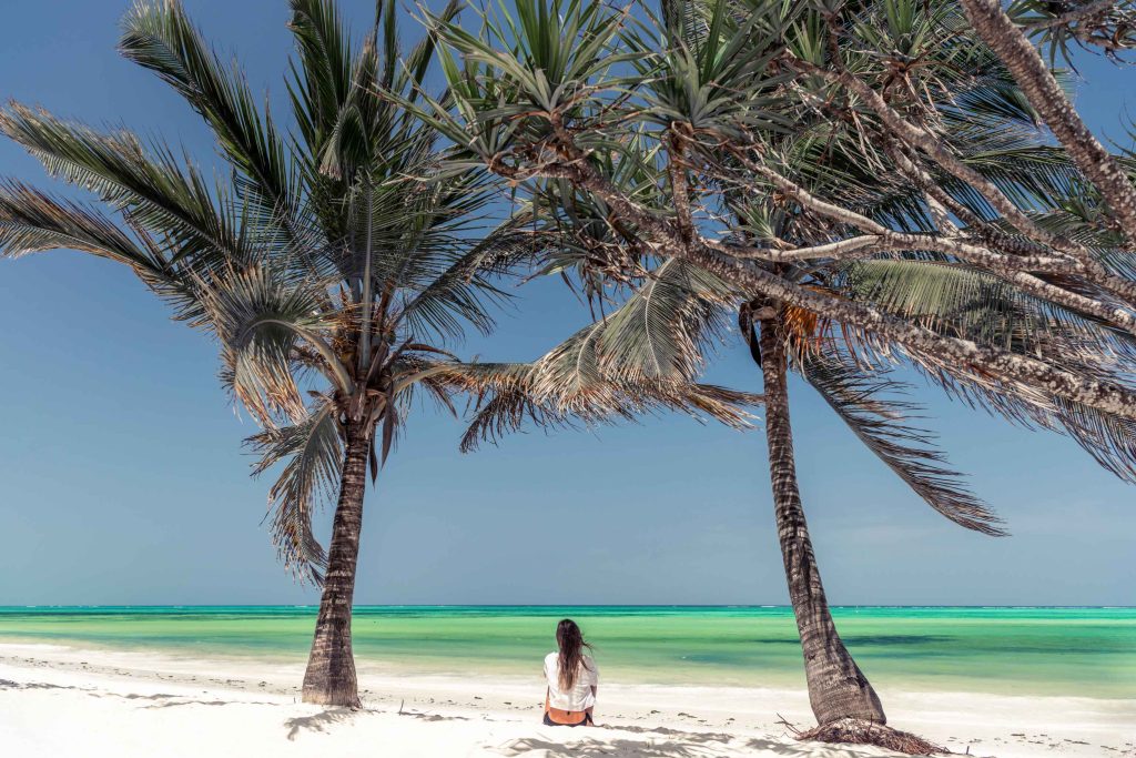big-game-trail-adventures-woman-sitting-at-the-beach