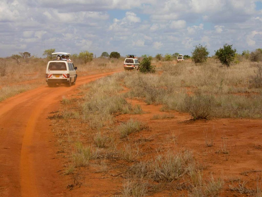 big-game-trail-adventures-tsavo-east-safari-buses-on-dirt-road-at-tsavo-east